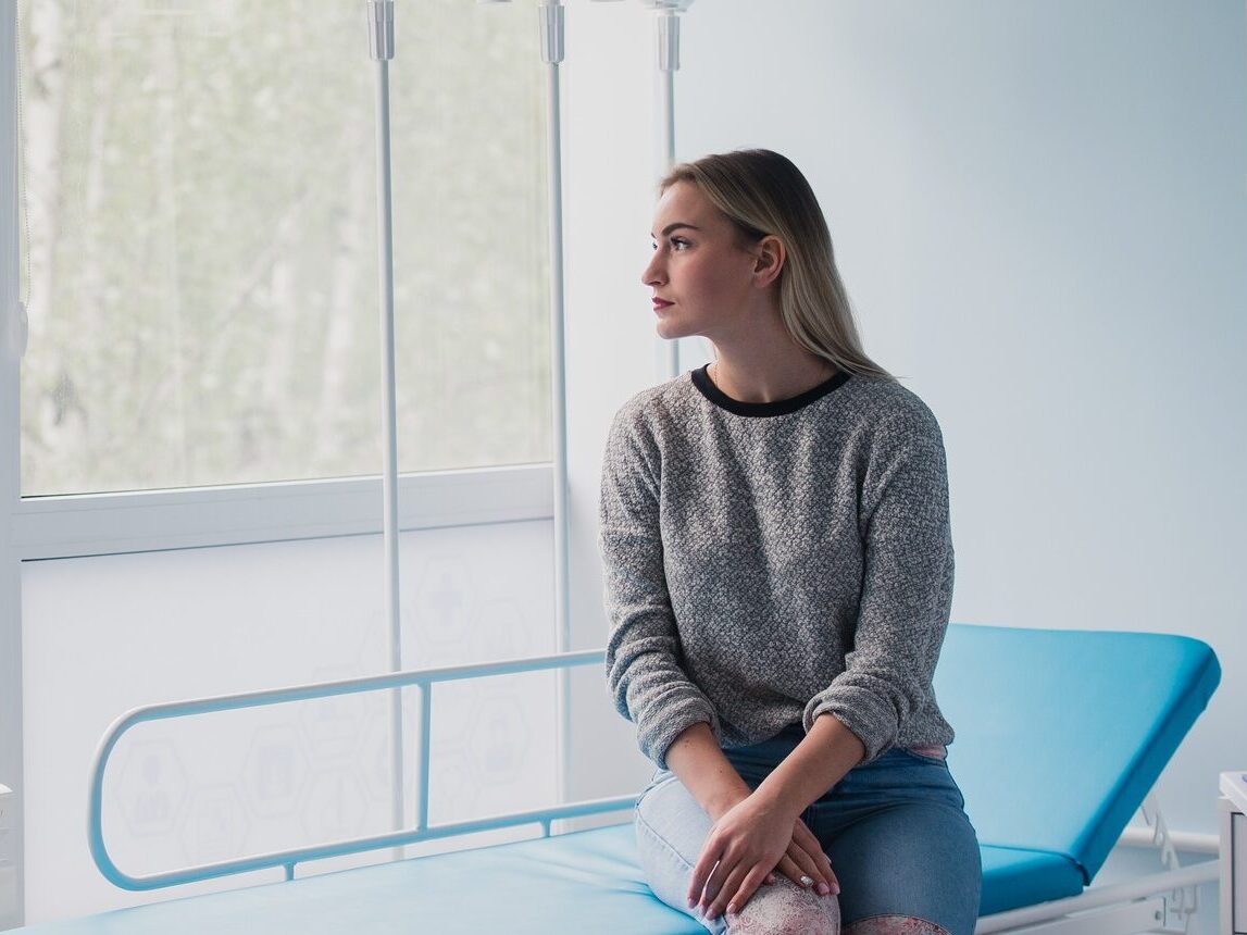 Full length portrait of a woman waiting for medical examination